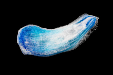 Beautiful blue smear of shaving foam on a black background isolated. Men's hygiene, skin care. Gel is smudged. Closeup. Cosmetic products. Top view. Colorful texture of cream. Trendy color.