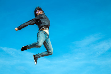 Obraz na płótnie Canvas hapy jumping asian woman on clear sky with active
