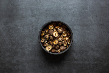 Dried Shiitake mushrooms on a dark background