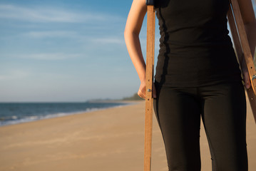 Patient woman hands using crutche support broken leg,Physical therapy concept