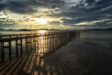 View of the wooden bridge in sunset time at Ranong, Thailand.