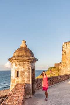 San Juan Puerto Rico tourists visiting famous landmark of Old Town, woman tourist taking selfie at Castillo San Felipe del Morro.