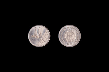 10 Uzbek som coin 2001 on a black background. close-up on both sides