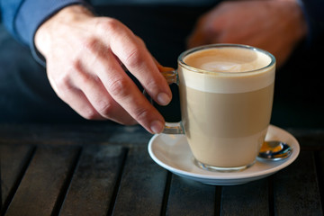 hand holding cup of coffee