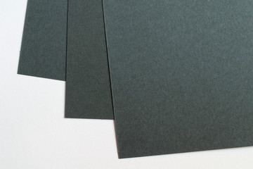 Blank black paper corners macro view selective focus on white as template for logo presentation, embossing etc.