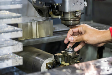 The  Wire EDM machine operator setting by insert the brass wire to the machine upper head. The mold...