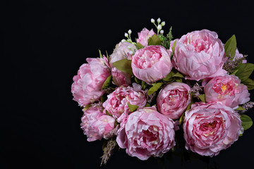 Beautiful bouquet of pink peonies . Floral composition on black background.
