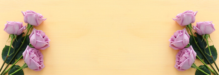 summer bouquet of pink roses flowers over wooden pastel background. top view, flat lay