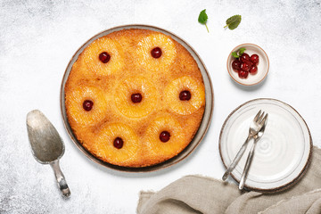 Fresh baked pineapple upside down cake with candied cherries and caramel. Flat lay. Homemade sweet...