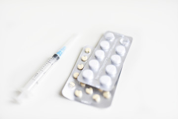 syringe and pills still life on a medical topic