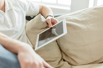 young man reading mail on a digital tablet