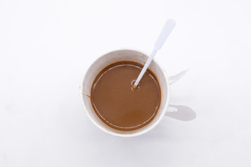 Top view of a paper cup of coffee on white background
