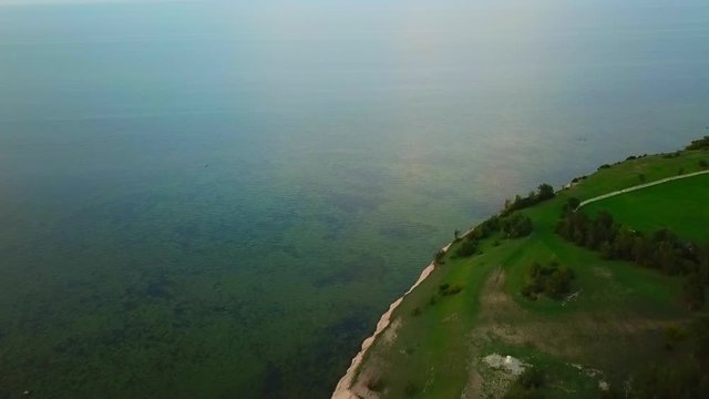 aerial orbit view of ocean and panga cliff at estonia saare county before sunset