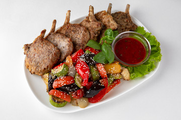 Rack of lamb, or rabbit shoulder blade, pork ribs with grilled vegetables. Banquet festive dishes....