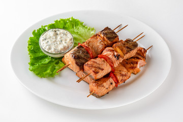 Grilled salmon skewers. Banquet festive dishes. Gourmet restaurant menu. White background.