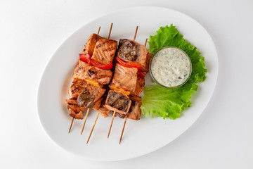 Grilled salmon skewers. Banquet festive dishes. Gourmet restaurant menu. White background.