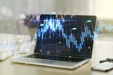 Multi exposure of abstract creative financial chart with world map on laptop background, research and analytics concept