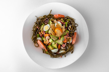 Salad of vegetables, seaweed, spaghetti and seafood. Banquet festive dishes. Gourmet restaurant...