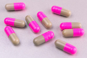 Capsules, pills (colored) on a gray background.Close-up.