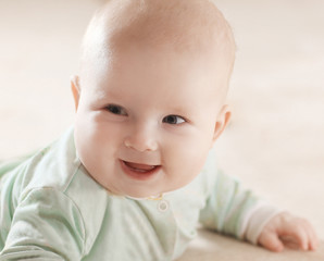 close up.portrait of a pretty little baby on blurred background.