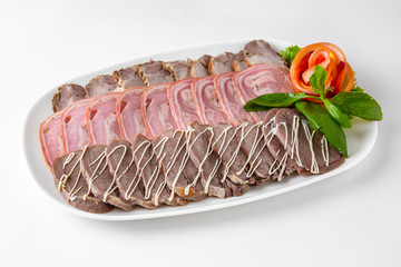 Sliced meat delicacies. Delicious beef, pork and poultry rolls stuffed with dried fruits and pastes. Banquet festive dishes. Gourmet restaurant menu. White background.