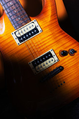 Musical concept. Electric guitar under a beam of light. Musical creativity.