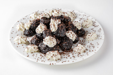 Dessert prunes stuffed with nuts and cream. Banquet festive dishes. Gourmet restaurant menu. White background.