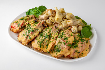 Meat chop with vegetables in egg batter with flour and noodles and mushrooms. Banquet festive dishes. Gourmet restaurant menu. White background.