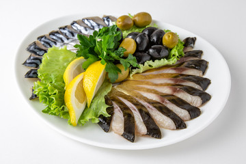 Plate with appetizer of fish and seafood. Sliced salted fish fillet. Smoked herring, salmon, perch,...