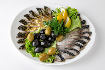 Plate with appetizer of fish and seafood. Sliced salted fish fillet. Smoked herring, salmon, perch,...