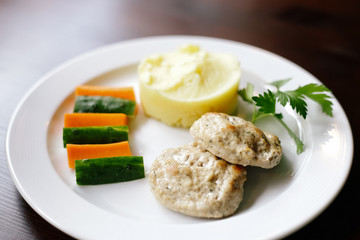 Meanced meat cotlets with mashed potatoes and fresh vegetables