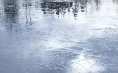 Fototapeta na wymiar Frozen lake shiny blue ice surface with reflections