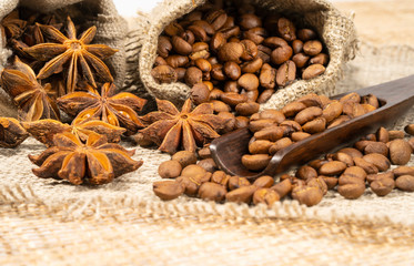 roasted coffee beans with cloth sack on wooden texture