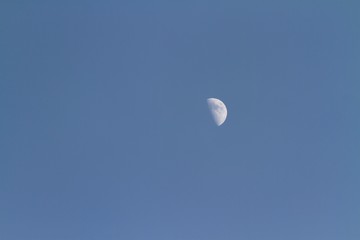 Glowing moon in sky background at dusk