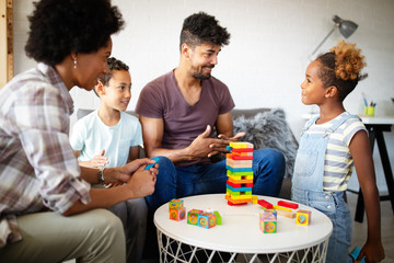 Happy black family playing game together at home