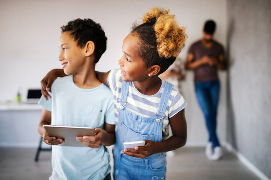 Happy children havig fun and using technology devices