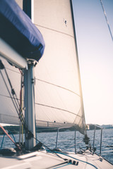 Obraz premium White cloth fabric, masts and ropes close-up on sail of tri-yacht or yacht sailing boat