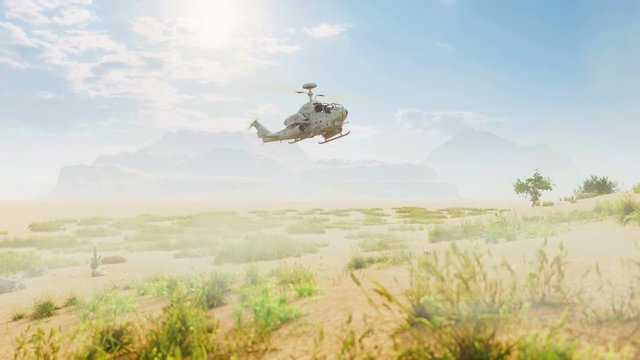 A military helicopter lands in the desert raising dust and sand. Special operation of the military.