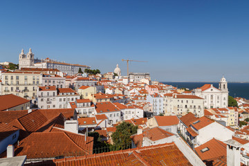 Church of Sao Vicente of Fora (Igreja de Sao Vicente de Fora), old buildings in Alfama and Graca districts and Tagus River in Lisbon, Portugal.