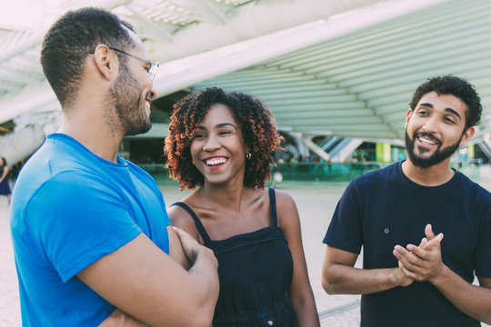 Multiethnic Group Of Friends Meeting Outside And Having Fun. Diverse Men And Women Standing At City Construction, Talking, Smiling, Laughing. Close Friends Concept