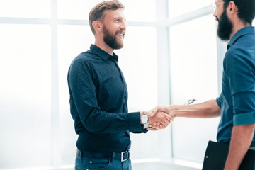 business people shaking hands in a bright office