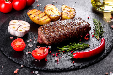 Ribeye steak with potatoes, onions and cherry tomatoes