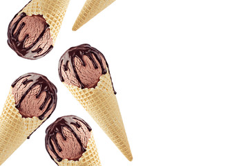 Decorative border of chocolate ice cream in waffle cones with sweet brown sauce isolated on white background.