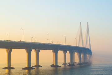 sunrise view of the sea link bridge connecting Mumbai city suburbs to Bandra made from pre-stressed concrete steel; Urban cable stayed suspension bridge in mumbai