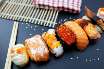 Sushi with chopsticks, Japanese sushi with soy sauce and wasabi.