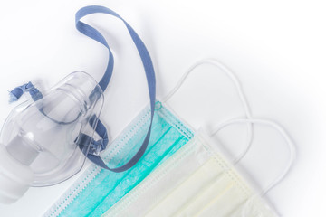 Medical ultrasonic inhaler or nebulizer oxygen mask and hygienic face masks on white background