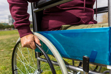 Man in wheelchair taking a walk in the park