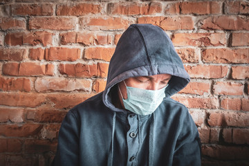 Naklejka na ściany i meble man in a hood and a medical mask