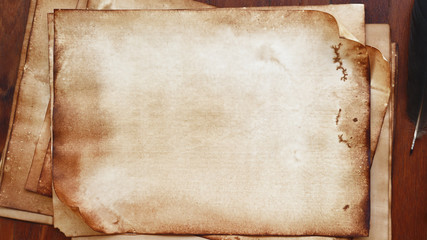 old paper on brown wood texture and feather for background