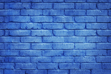 Brick wall painted in classic blue color. Abstract modern trendy texture background